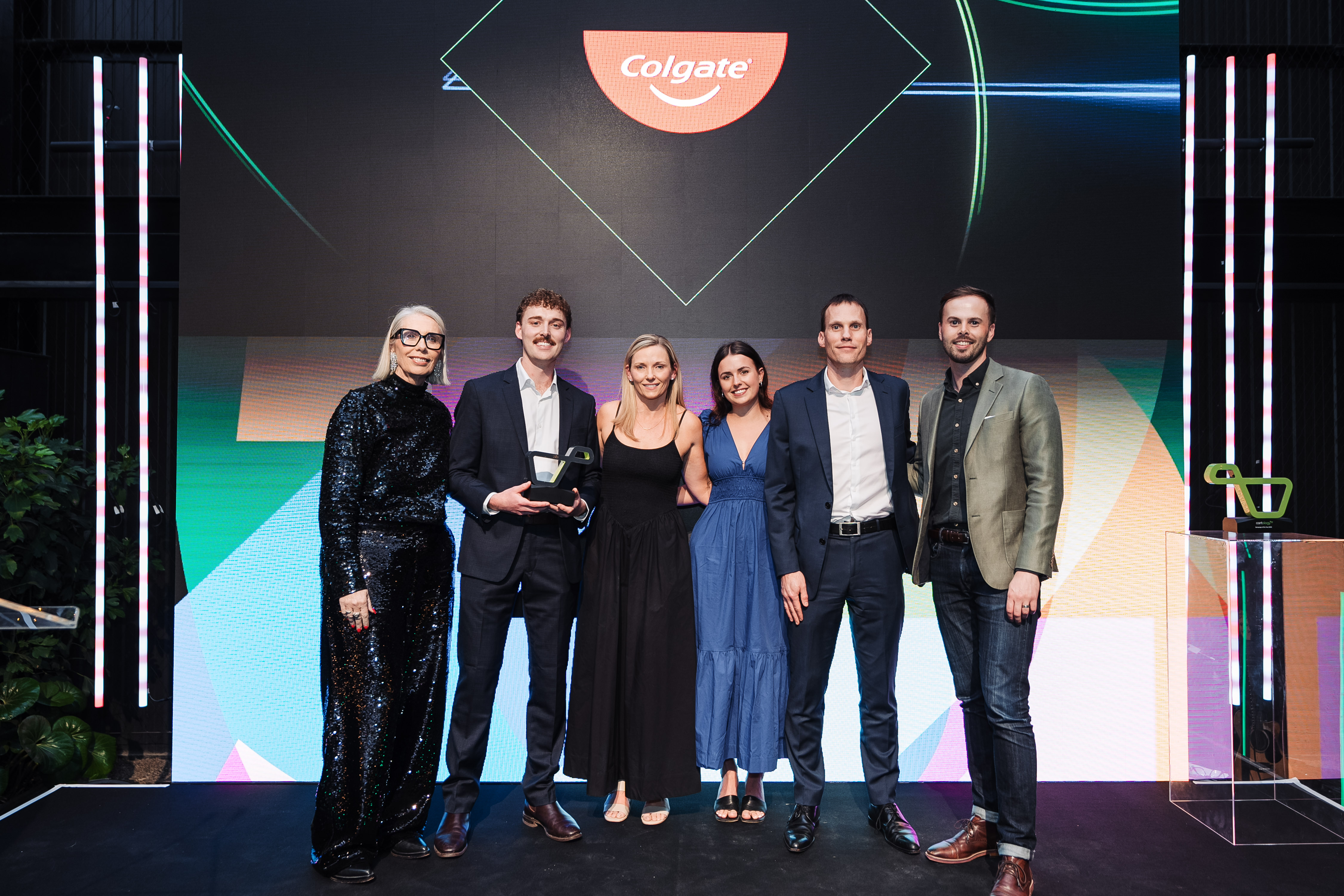 woman with shopping cart in toothpaste aisle of store